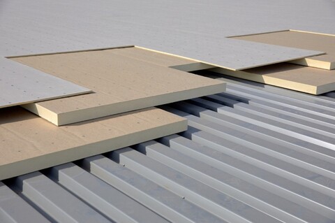 Low-slope roof assembly with FPIS ci insulation entirely above roof deck